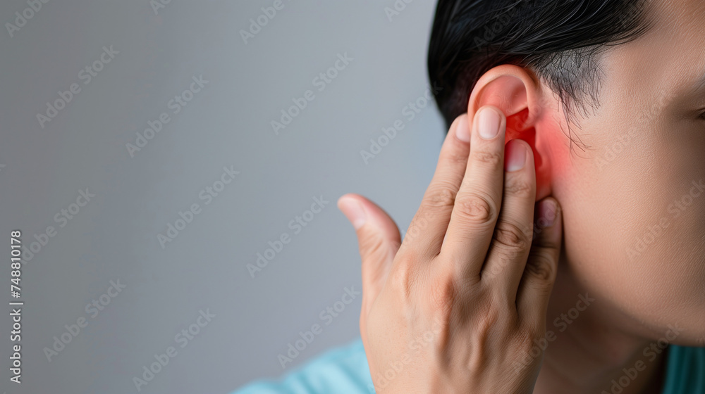 Woman with her hand on her ear. Concept of ear pain, otitis, ear plug ...