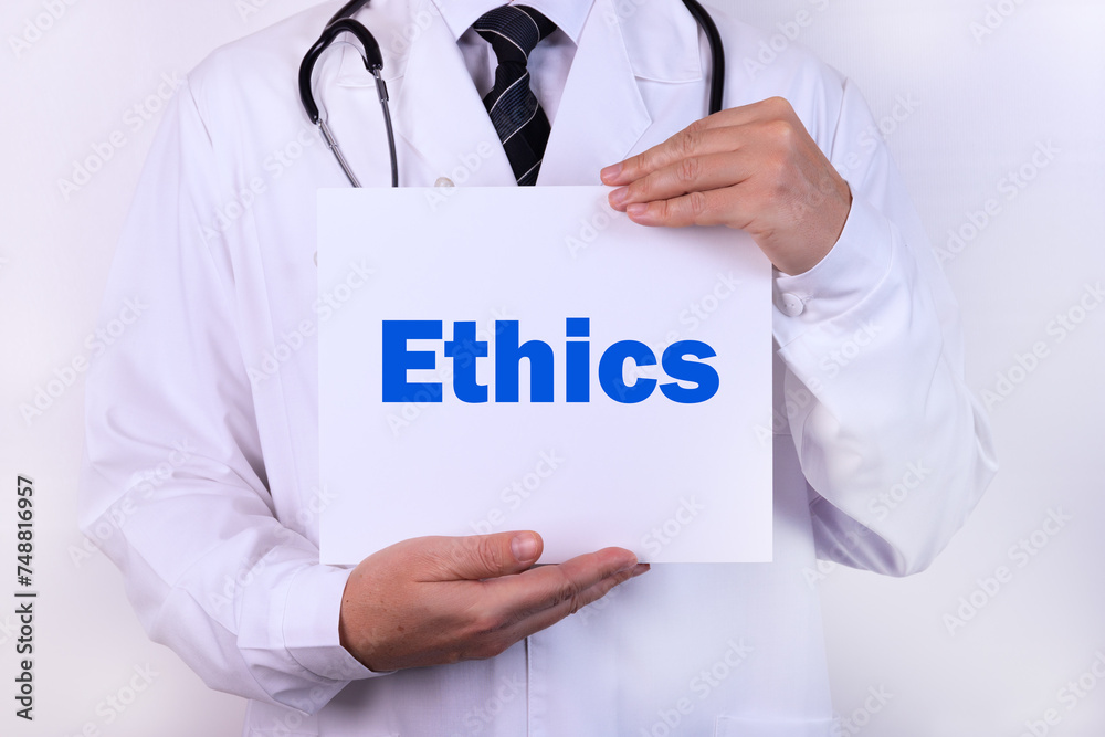 Doctor holding a card with Ethics medical concept Doctor holding a card with Ethics medical concept