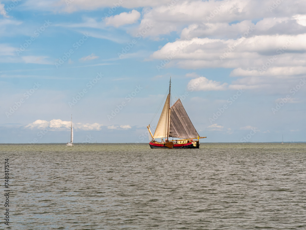 Historic tjalk charter ship sailing on IJsselmeer lake, Netherlands