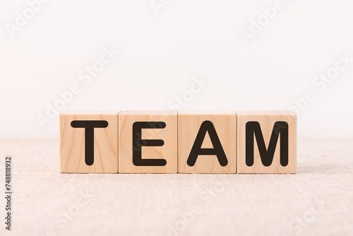 TEAM word concept written on a light table and light background