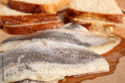 Pickled herring and bread. Salted, soused skinless fillets of fish Clupea.