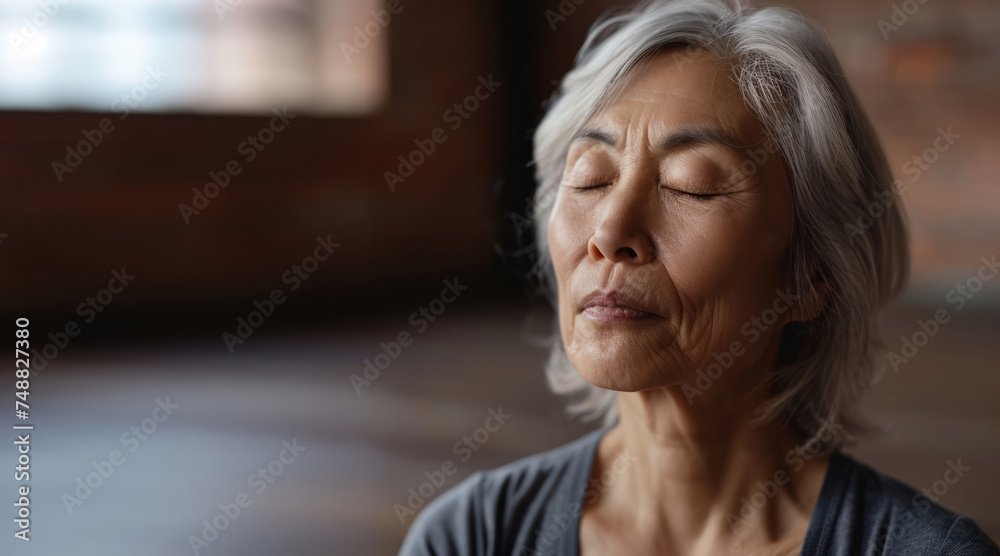 Close up Portrait of elderly woman sits in the lotus position meditating in a yoga studio. Mental and spiritual health development at any age
Close up Portrait of elderly woman sits in the lotus position meditating in a yoga studio. Mental and spiritual health development at any age