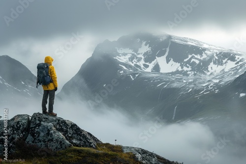 Mountaineer overlooking a foggy mountain range.