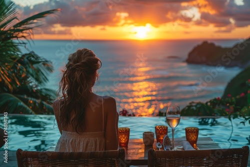 A serene woman relaxing on a rattan chair witnessing a stunning ocean sunset from an exotic poolside location