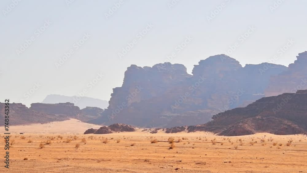 Jordan -15th october, 2022: Wadi rum desert landscape with 4wd enter frame drive safari tour in hot day weather with stunning landscape background