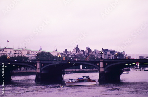 Looking toward the Westminster Bridge, the royal horseguards hotel and Charing Cross Station along the River Thames in London during early 1990s