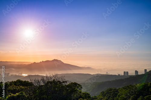 The sun, mountains and clouds create a wonderful symphony at dusk. Enjoy the sunset and sea of clouds. Zhongzhengshan Hiking Trail, Taipei City. © twabian