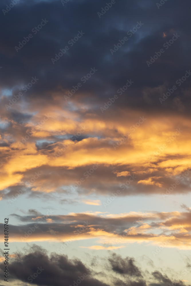 Bright yellow clouds at sunset in sky