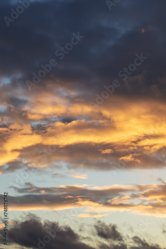 Bright yellow clouds at sunset in sky