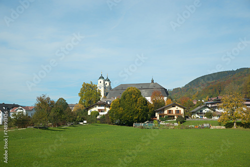 historic Basilika St. Michael, tourist resort mondsee, green meadow and blue sky