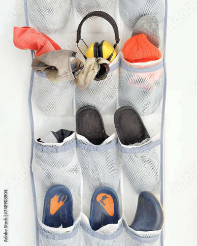 Messy over the door organizer with various clothing accessories