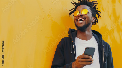 young man with a joyful expression is using his smartphone