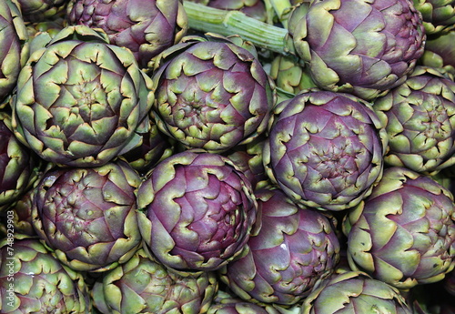 Background of large ripe green artichokes for sale photo