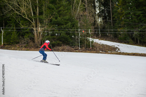 a skier is skiing on a steep hill photo