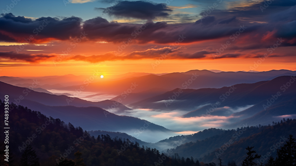 Colorful orange sunset on top of mountain. cloudy and foggy landscape.