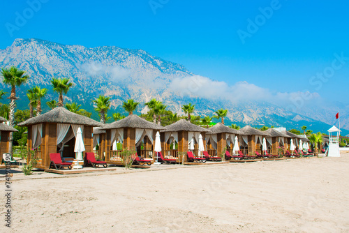 Wooden beach pavilions on the shore of a sandy beach