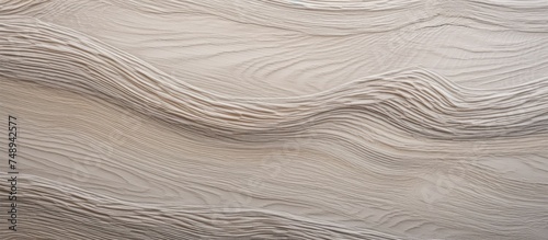 A detailed view of a wall covered in Sand Erable veneer with distinctive wavy lines in a grey color. The texture adds a dynamic and modern touch to any home design scheme.