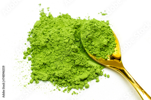 Green tea extract with golden spoon isolated white background photo