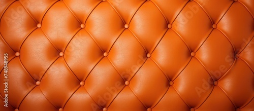 A vintage orange leather upholstered wall with button detailing  creating a textured backdrop. The genuine leather material is scratched  adding character to the design.