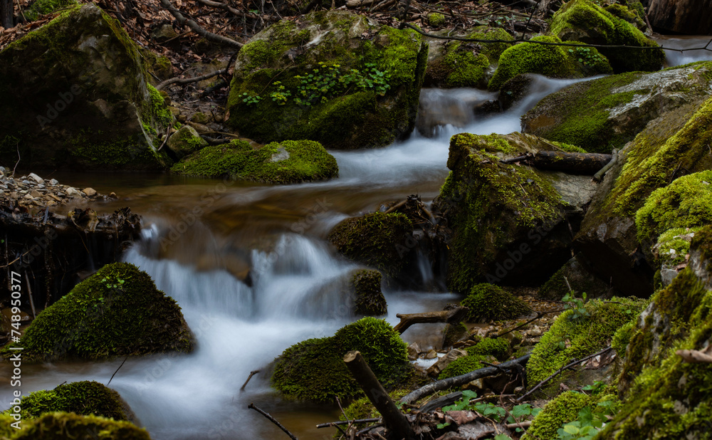 Small waterfall in the forest stream with green moss. Small waterfall in the forest stream with green moss.