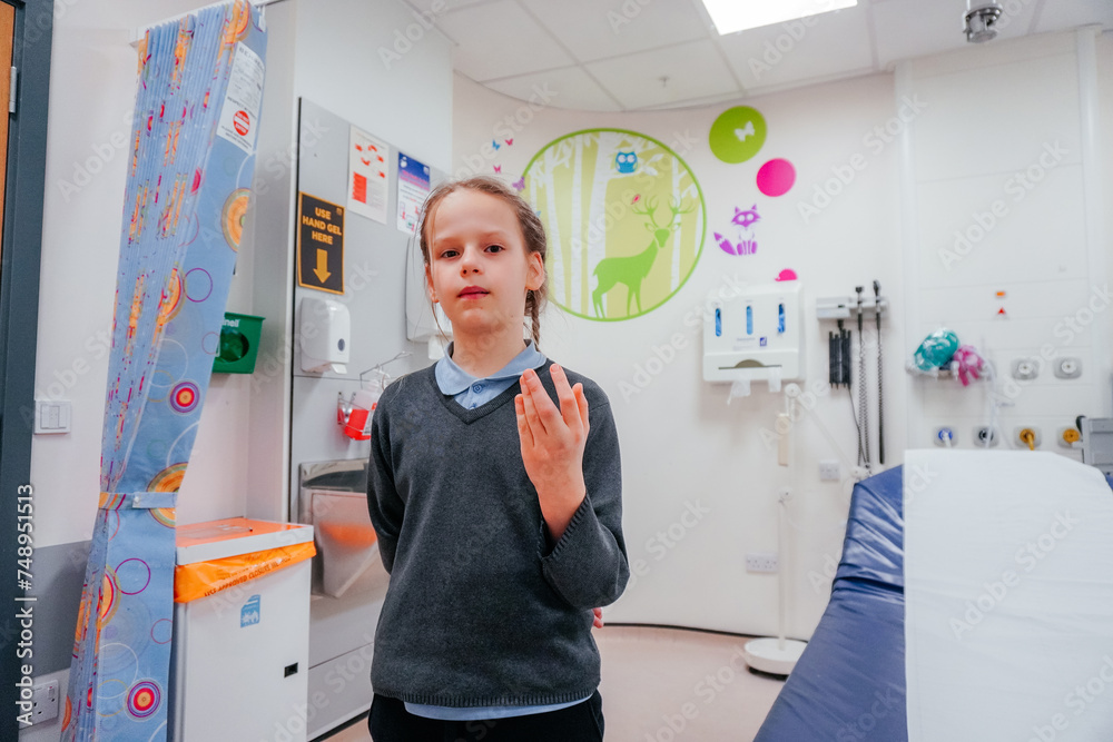 Pediatric Healthcare: Girl with Injured Finger in Hospital Room Pediatric Healthcare: Girl with Injured Finger in Hospital Room