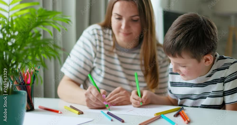 Mother and son enjoying drawing together at home Mother and son enjoying drawing together at home