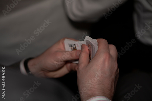 businessman holding playing cards