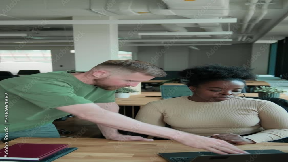 Vertical of chief manager helping new employee with work Vertical of chief manager helping new employee with work