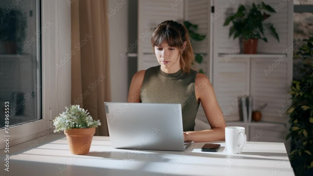 Busy businesswoman working on laptop in green office Busy businesswoman working on laptop in green office