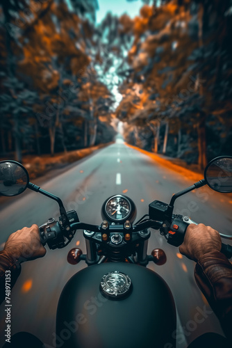 Closeup of two hands on motorcycle handlebars, motorcyclist on paved road. © S photographer