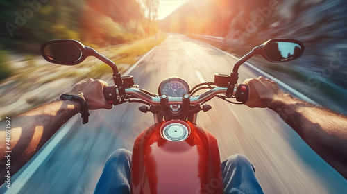 Closeup of two hands on motorcycle handlebars, motorcyclist on paved road. © S photographer