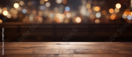 A dark wooden table is shown with blurry lights in the background  creating an abstract and atmospheric scene suitable for displaying or montaging products.