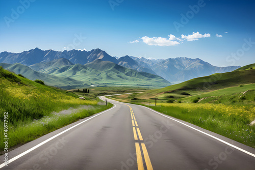 Open Road Adventure: An Inviting Asphalt Road to The Horizon Between Mountains and Blue Sky © Edith
