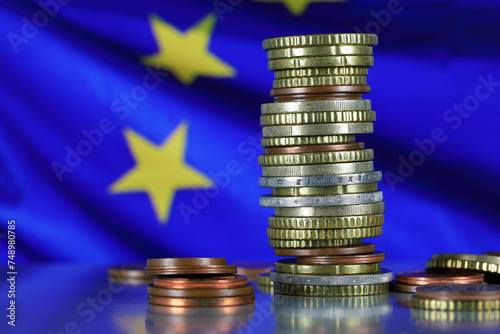 Euro coins against the European flag