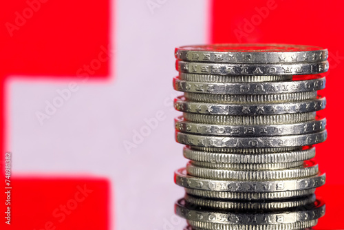 Pile of Swiss francs and the Swiss national flag photo