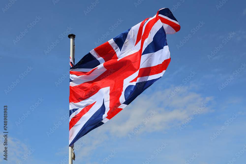 United Kingdom flag waving against a blue sky