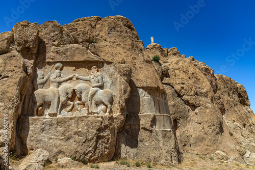 Iran, Fars Province. Naqsh-e Rostam, archaeological site known for its Achaemenid tombs and rock reliefs made in the Sasanian age. Rock relief of Ardasir I (left side) and first relief of Bahram II photo