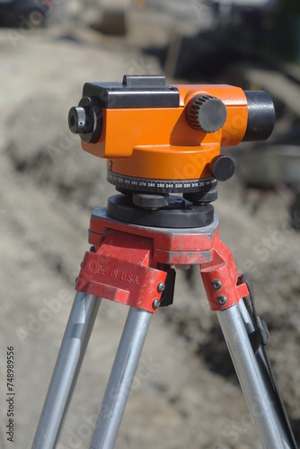 A red and silver tripod with a black and orange top