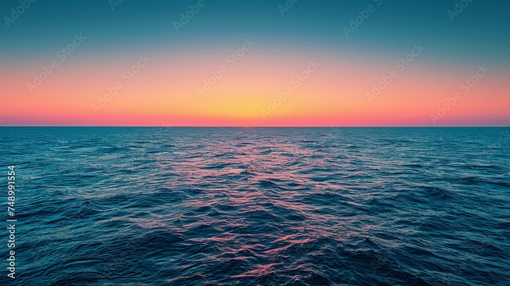 sunset on the horizon, with the sun casting a warm glow over the sky and the sea