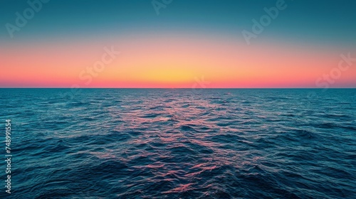 sunset on the horizon, with the sun casting a warm glow over the sky and the sea