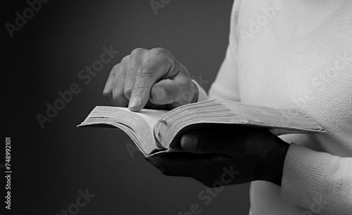 man praying to god with hands together Caribbean man praying with people stock image stock photo 