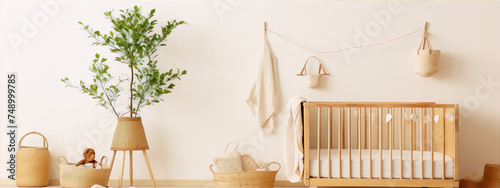 Cute nursery room with a wooden crib and a plant in a basket photo