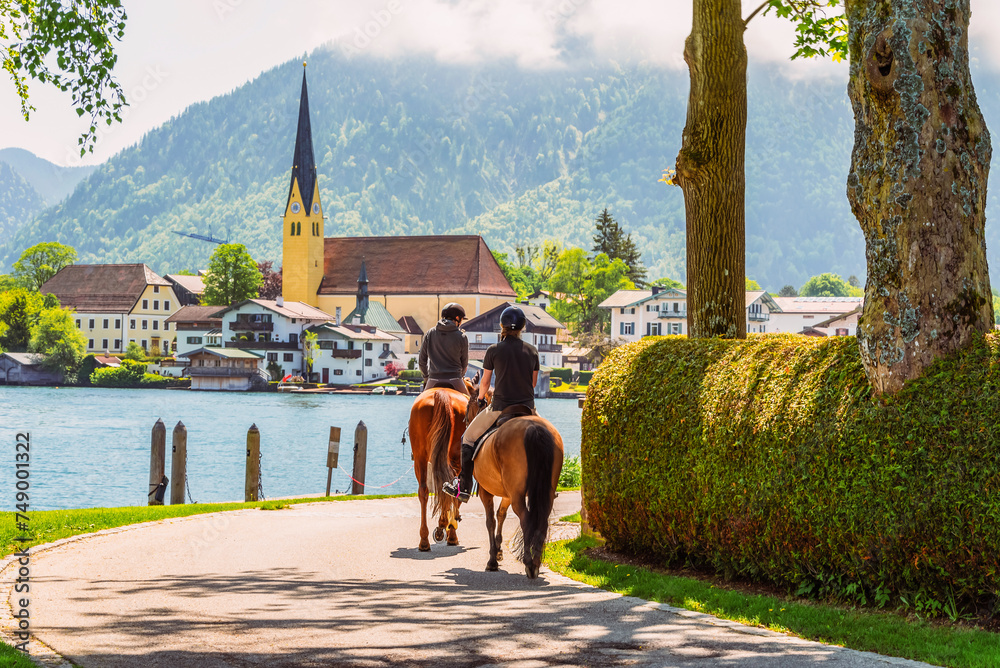 Horseback riding along the shore of Lake Tegernsee on a sunny summer day