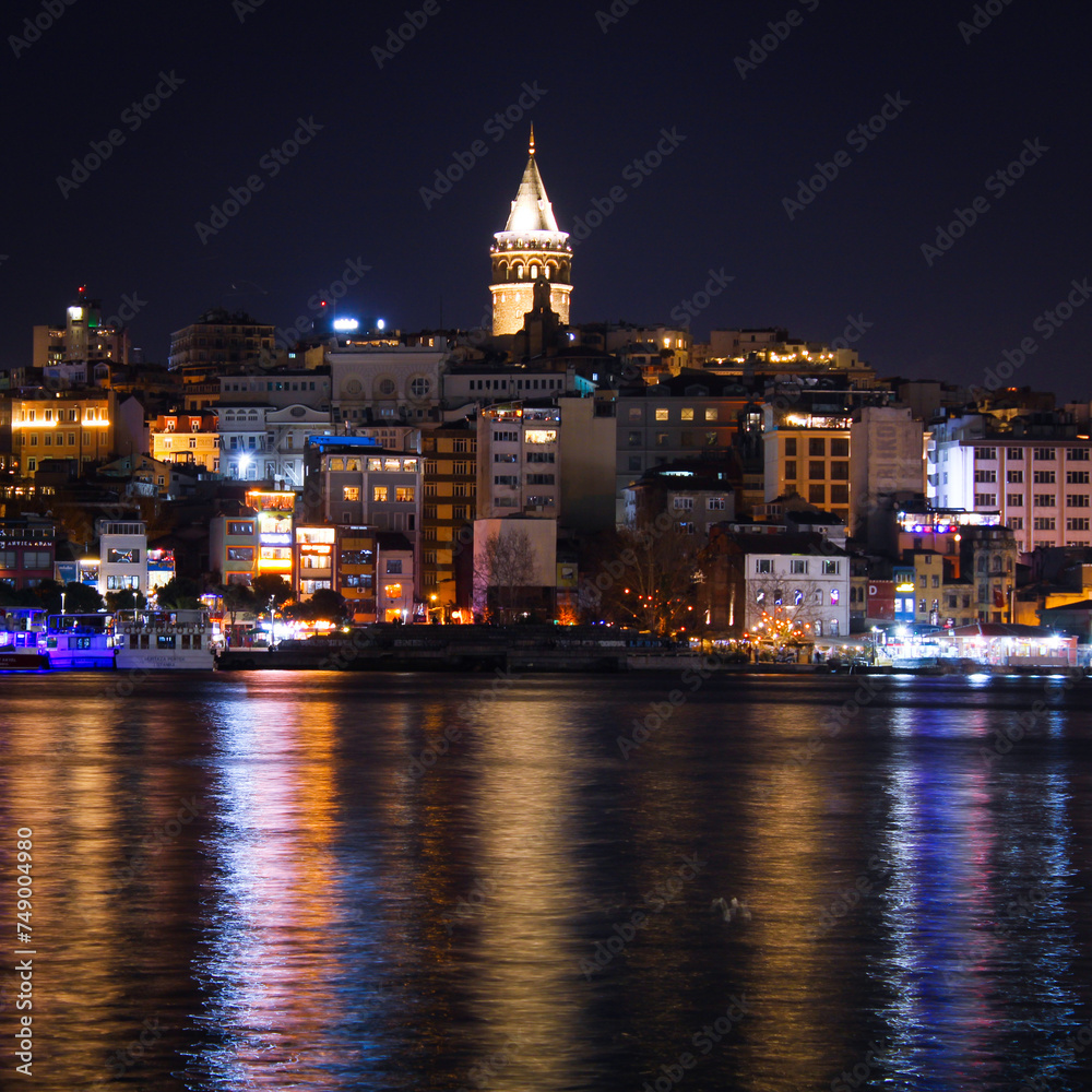 Reflection of Istanbul Galata Tower and buildings on the sea
