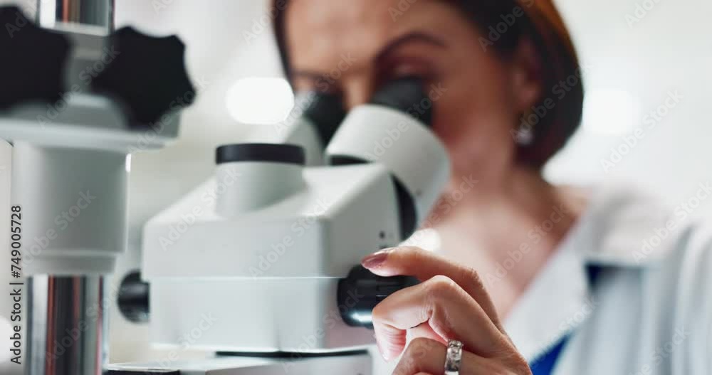 Woman, scientist and forensic research with microscope for science, microbiology or discovery at laboratory. Closeup of person or researcher looking in scope or lens for scientific breakthrough test