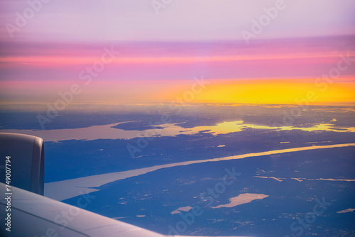 Dramatic Sunset Cloudscape and airplane wing, a view over Seoul Incheon International Airport, South Korea, a tranquil high altitude scenery at twilight