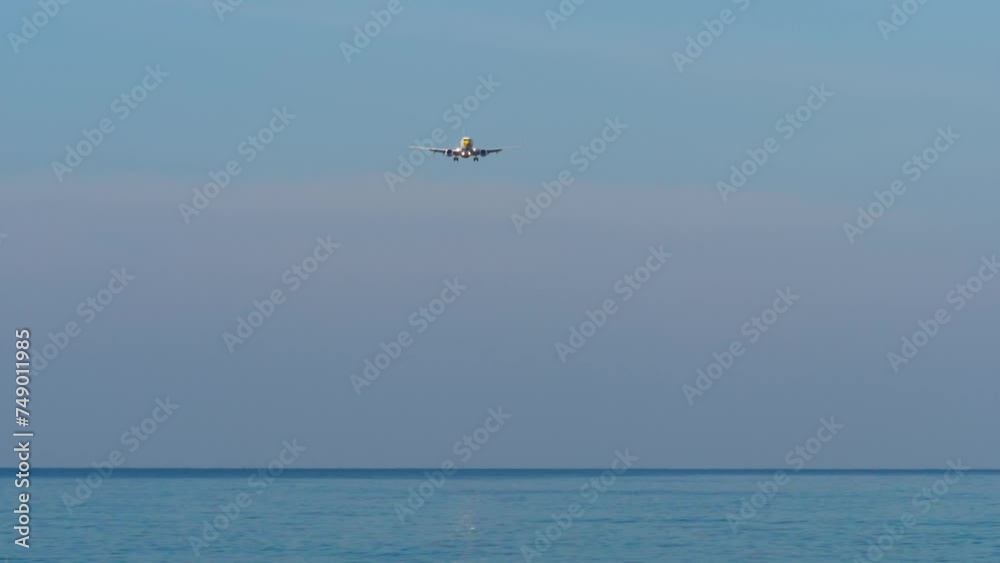 Commercial jet plane landing approach, blue sky, long shot. Footage of a passenger airliner flying. Tourism and travel concept Commercial jet plane landing approach, blue sky, long shot. Footage of a passenger airliner flying. Tourism and travel concept
