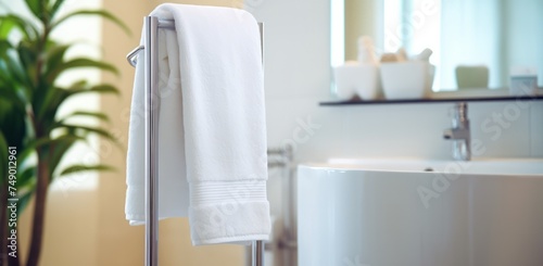 a towel stand showing a white towel inside a bathroom