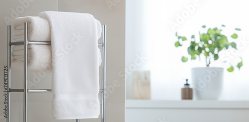 a towel stand showing a white towel inside a bathroom