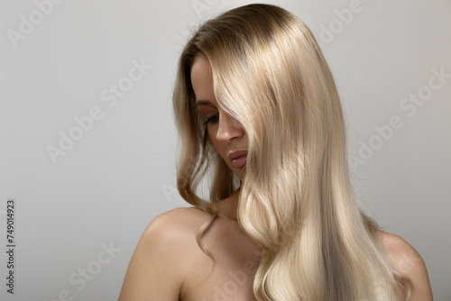 Blonde with long wavy hair. Beautiful fashion woman